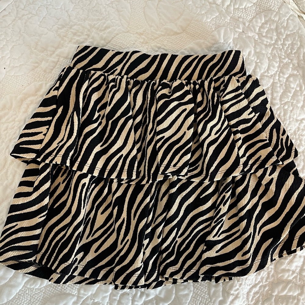 Ruffled, off white zebra print skirt.